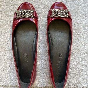 Beautiful red patent flat shoes with a silver accent.